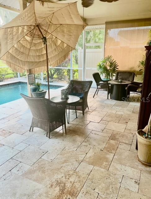 exterior space with a patio, a lanai, and ceiling fan