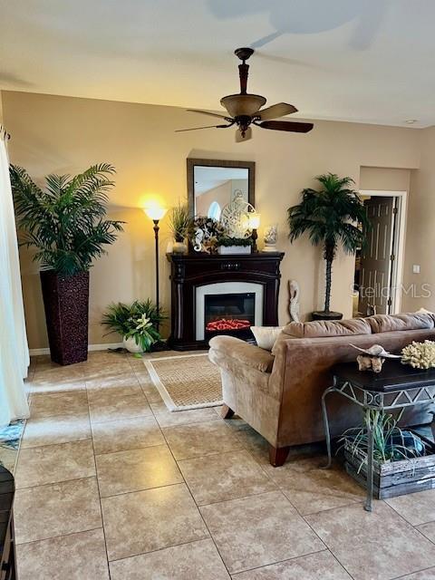 living room with ceiling fan and light tile patterned floors