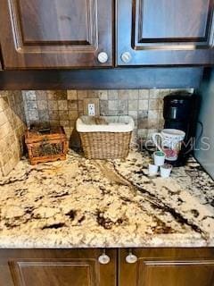 details with light stone countertops and backsplash