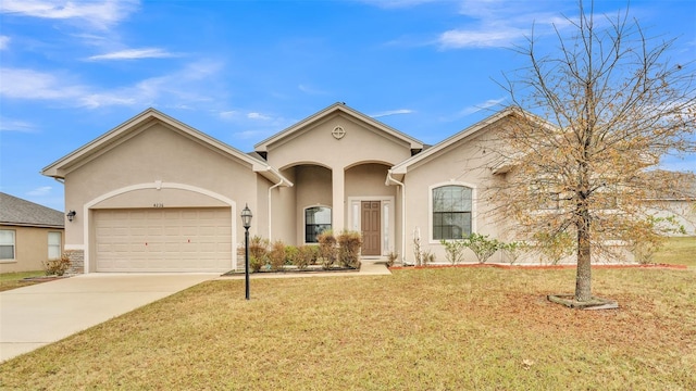 view of front of home with a garage and a front yard