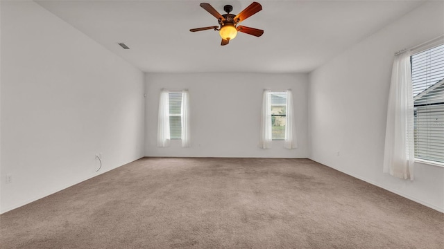 empty room with ceiling fan and carpet flooring