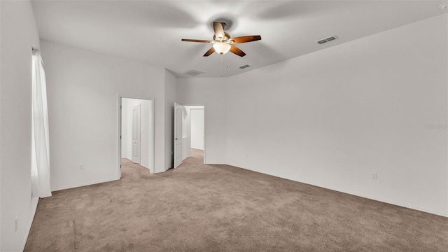 unfurnished bedroom featuring ceiling fan, a towering ceiling, and light carpet