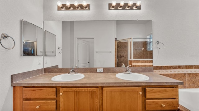 bathroom featuring vanity and independent shower and bath