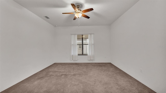 carpeted spare room with ceiling fan