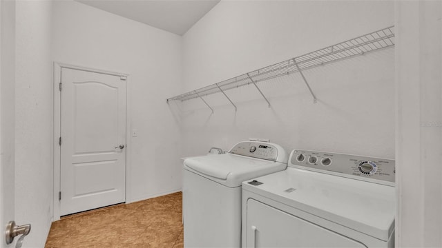 washroom with washing machine and dryer and light tile patterned floors