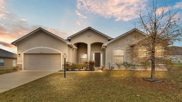 view of front facade with a garage and a yard