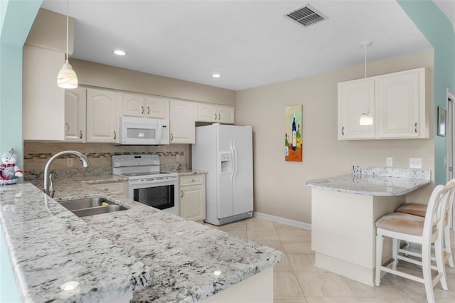 kitchen featuring white appliances, sink, and white cabinets