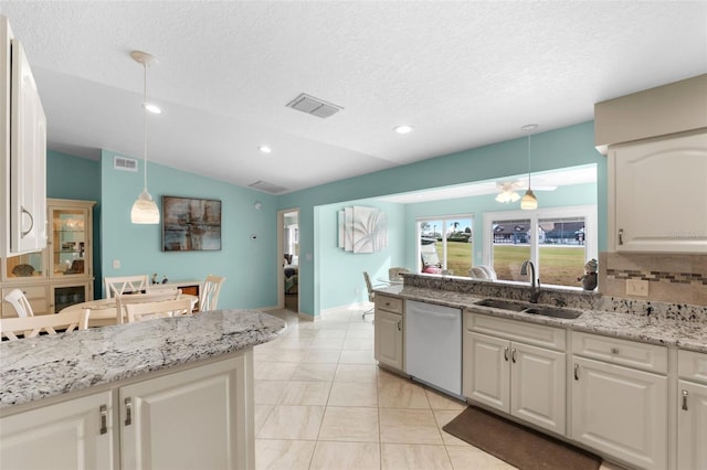 kitchen with sink, white cabinetry, dishwasher, and hanging light fixtures