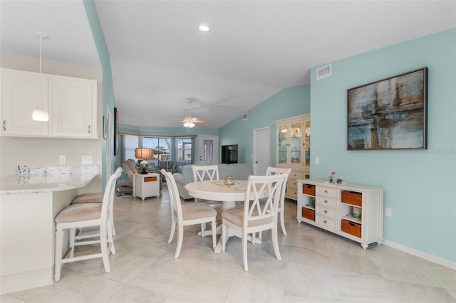 dining space with ceiling fan and vaulted ceiling