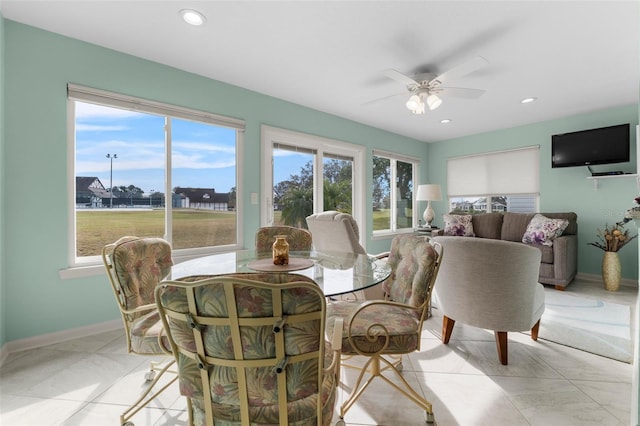 tiled dining room with ceiling fan