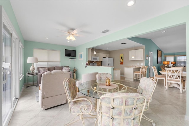 dining area with ceiling fan and lofted ceiling