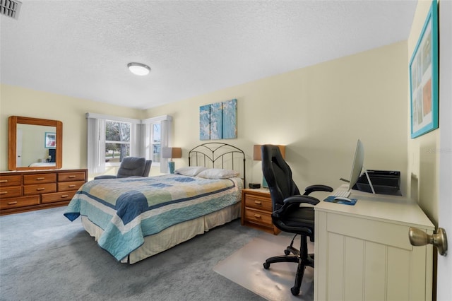 carpeted bedroom with a textured ceiling