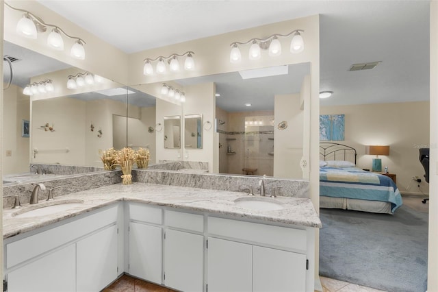 bathroom with walk in shower and vanity