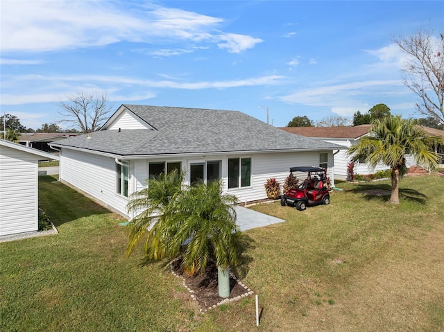 rear view of house with a yard