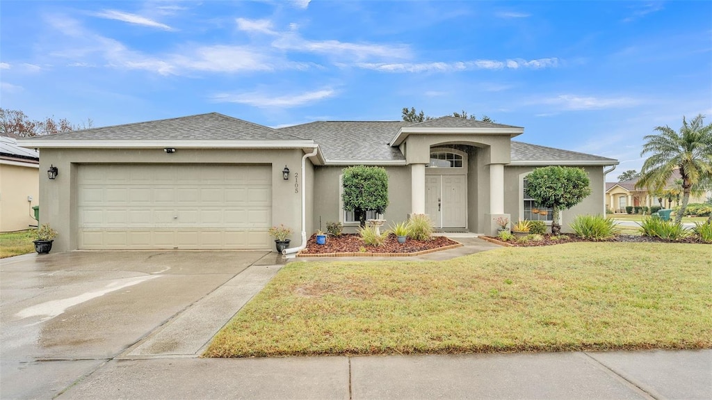 view of front of house with a garage and a front yard