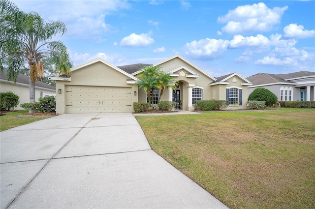 ranch-style home with a garage and a front yard