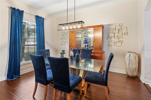 dining space with dark hardwood / wood-style flooring