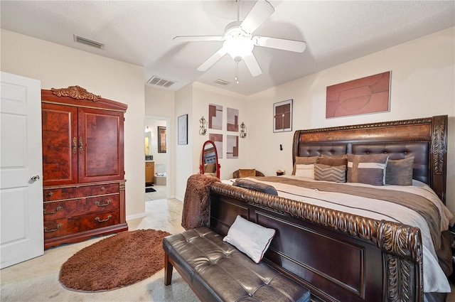 bedroom featuring ceiling fan, light colored carpet, and a textured ceiling