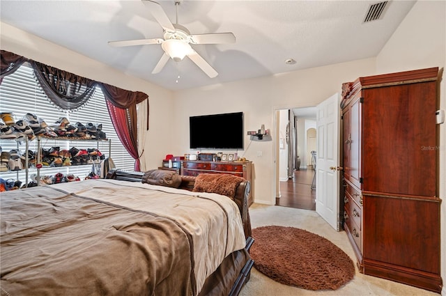 bedroom featuring ceiling fan and light carpet