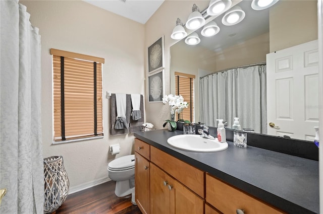 bathroom with wood-type flooring, toilet, and vanity