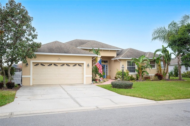 view of front of home featuring a garage and a front yard