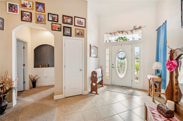 tiled entryway with a towering ceiling