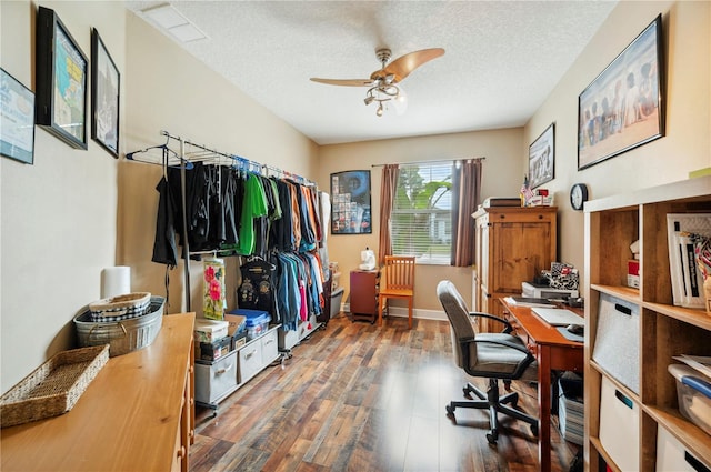 office area with dark wood-type flooring, a textured ceiling, and ceiling fan