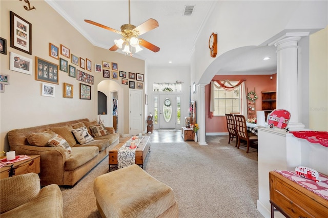 living room with ornamental molding, carpet floors, ceiling fan, and ornate columns