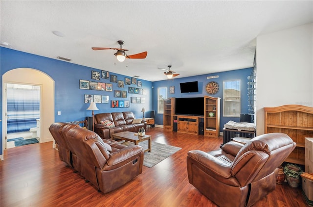 living room with hardwood / wood-style floors, a textured ceiling, and ceiling fan