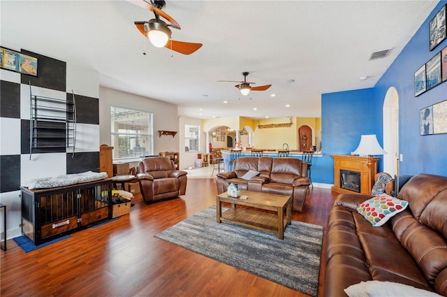 living room with ceiling fan and hardwood / wood-style floors