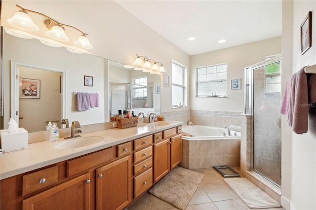 bathroom with plus walk in shower, vanity, and tile patterned flooring