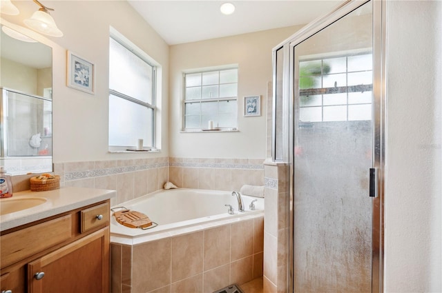 bathroom featuring vanity and shower with separate bathtub