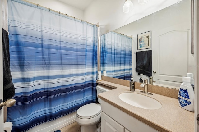 bathroom with toilet, vanity, and a shower with shower curtain