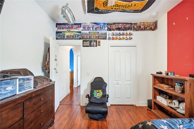 bedroom with hardwood / wood-style floors and a closet