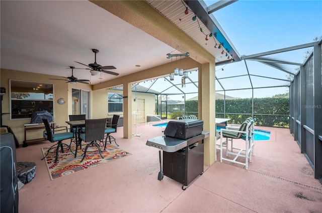 view of patio featuring ceiling fan and a lanai