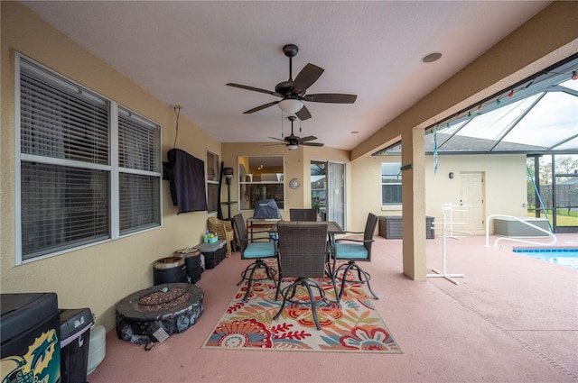 view of patio / terrace featuring glass enclosure and ceiling fan