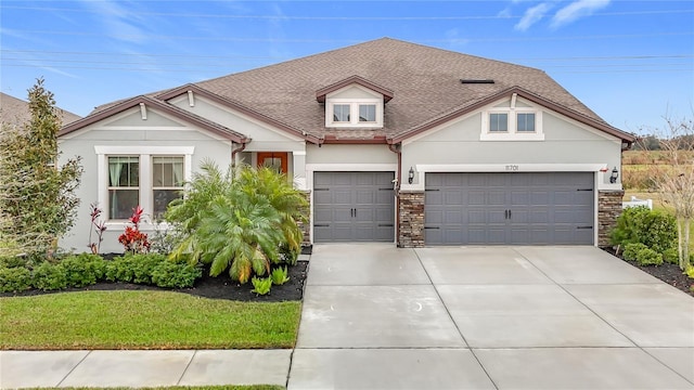 view of front facade featuring a garage and a front lawn