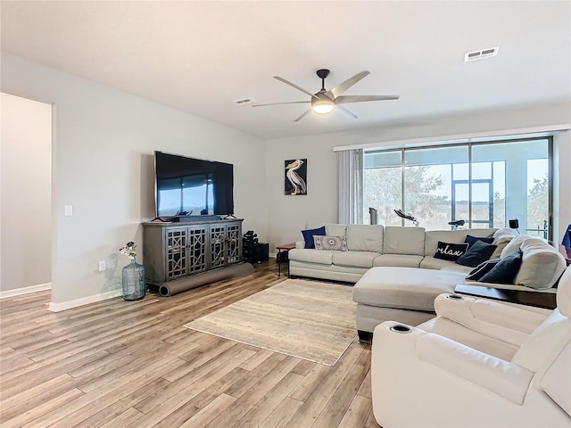 living room featuring light wood-type flooring and ceiling fan