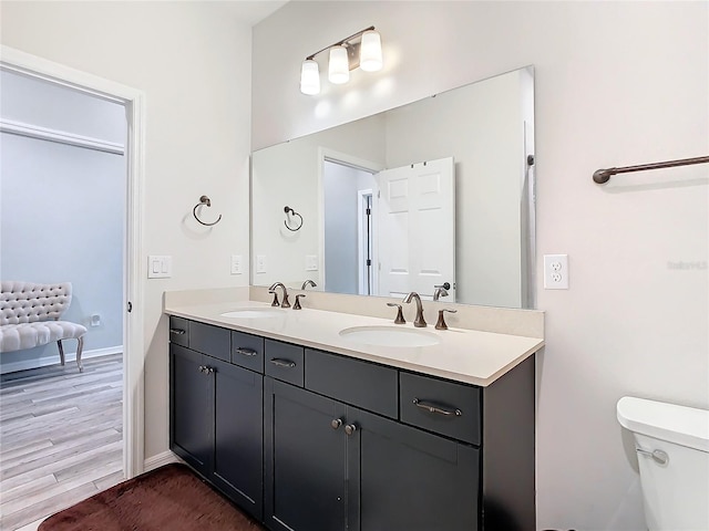 bathroom featuring hardwood / wood-style flooring, toilet, and vanity