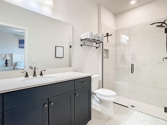 bathroom with vanity, toilet, walk in shower, and tile patterned flooring