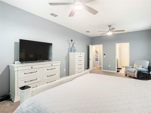 bedroom with ceiling fan and light colored carpet