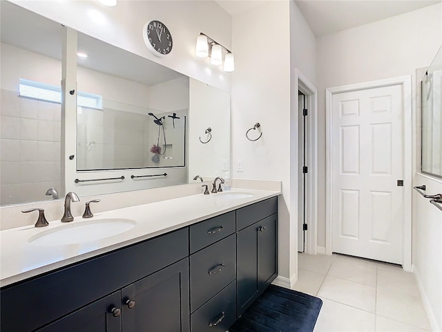 bathroom featuring walk in shower, vanity, and tile patterned flooring