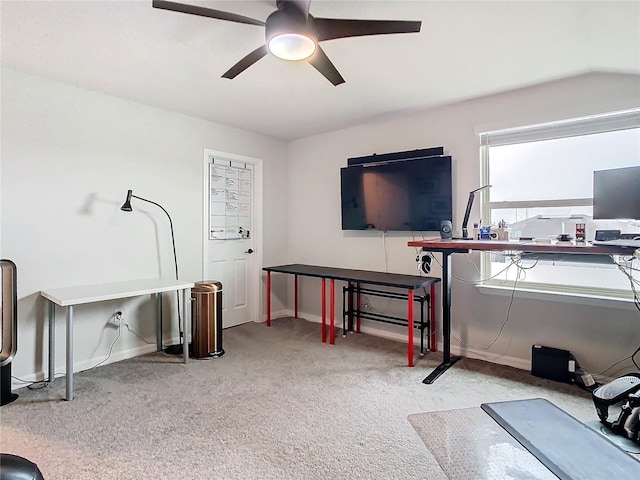 exercise area featuring light carpet and ceiling fan