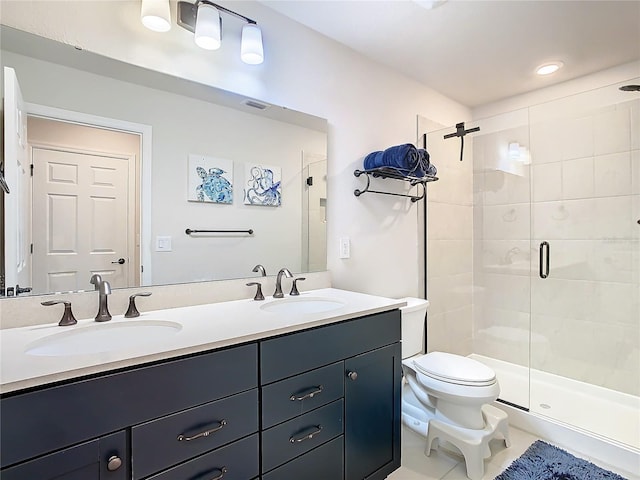 bathroom with toilet, a shower with shower door, and vanity