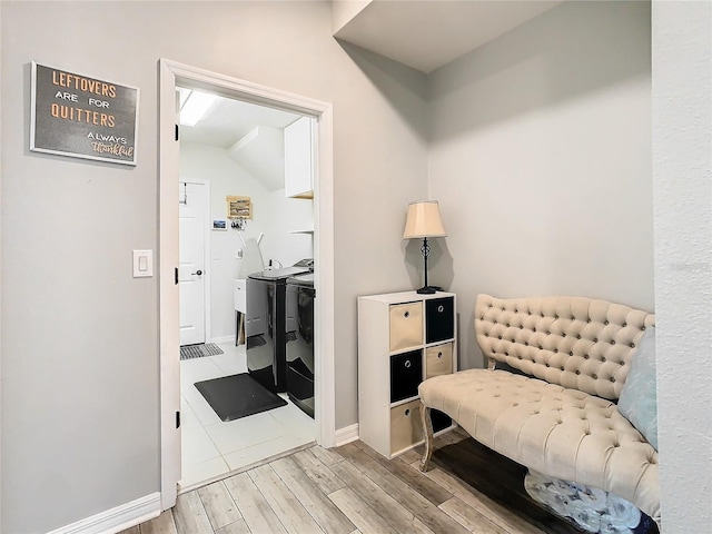 living area with vaulted ceiling and independent washer and dryer