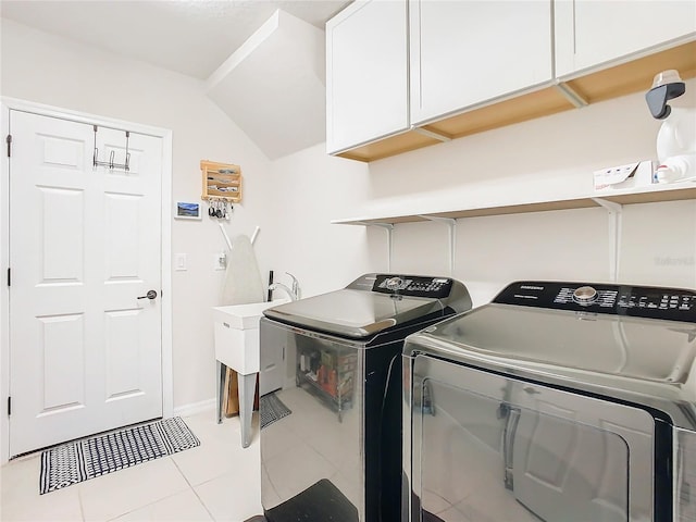 washroom with cabinets, independent washer and dryer, and light tile patterned flooring