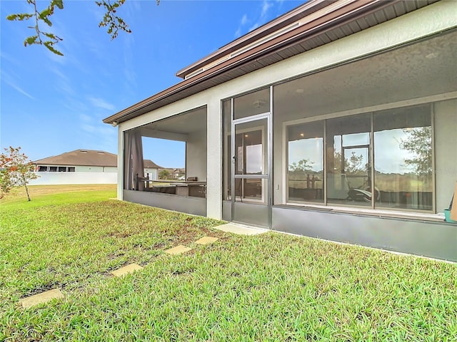 view of yard featuring a sunroom