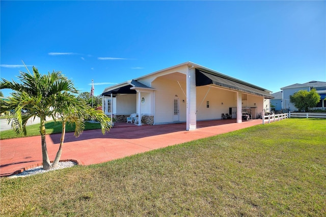 back of property featuring a patio and a lawn