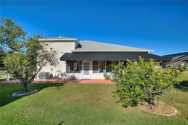 back of property with cooling unit, a lawn, and a patio area