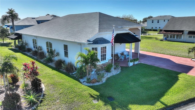 view of side of home with a yard